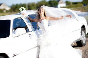 Young Bride Standing Beside limo limousine