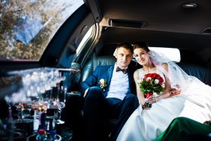 wedding couple inside the limousine